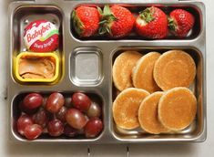 a metal tray filled with different types of food and fruit on top of each other