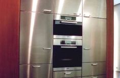 a kitchen with stainless steel appliances and cabinets