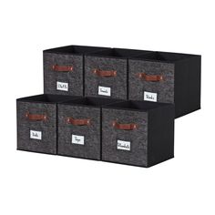 four storage bins with leather handles and labels on the front, two are dark grey