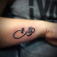 a tattoo on the arm of a person with a name and an initial in it