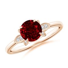 a ring with a red stone and two white diamonds