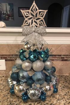 a christmas tree made out of silver and blue ornaments