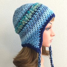 "Women's crocheted earflap hat. Teen earflap beanie with tassels. FREE SHIPPING! This earflap hat is a step beyond my basic earflap beanie...see this listing: https://www.etsy.com/listing/665409044/earflap-beanie-earflap-hat-beach-hat?ref=shop_home_active_26&frs=1 With this new listing I have added a decorative stripe of different yarns in the middle of the hat. I crochet a thin contrasting color (also found in the edge around the hat), followed by a coordinating bulky boucle yarn, and then Beanie Earflap, Crochet Earflap Hat, Thread Projects, Crochet Thread Projects, Earflap Beanie, Earflap Hat, Boucle Yarn, Crochet Thread, Trapper Hats