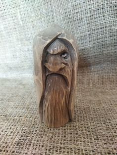 a wooden carving of a man with a beard