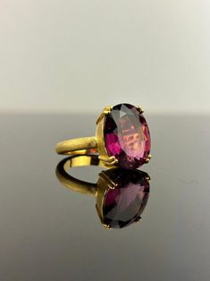 Make a statement with this beautiful 9.45 carat Pink Tourmaline cocktail ring, set in solid 18K matte finished Yellow Gold. The center stone has a beautiful pink color, with great luster and is absolutely transparent. The ring is sized at US7, can be resized.  18K Yellow Gold : 8.02 Grams  Pink Tourmaline : 9.45 Ctw Cocktail Ring, Pink Tourmaline, Cocktail Rings, Solitaire Ring, Rings Statement, Oval Shape, Ring Set, Tourmaline, Pink Color