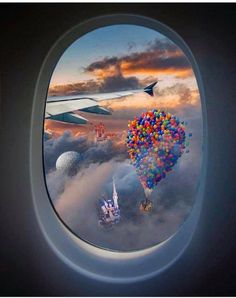 an airplane window with some balloons in the sky