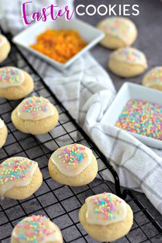 cookies with sprinkles are on a cooling rack next to bowls of powdered sugar