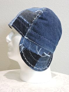 a white mannequin head wearing a denim hat