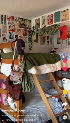 a bed room with a wooden bunk bed next to a wall covered in posters and pictures