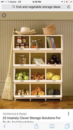 a shelf filled with lots of different types of fruits and vegetables next to a broom