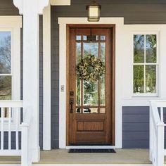 a front door with a wreath on it