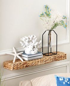 a wicker shelf with flowers and books on it