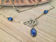 Length : 43 cm  Antiqued brass Art Nouveau inspired lily stamping, replica of Guyot stamping : 30x20 mm Sodalite cabochon in Victorian style antiqued brass setting : 14x10 mm Montana blue faceted glass cabochons : 10x8 mm. Glass cabs are faceted in Germany, settings are US made. Nickel free, lead free, cadmium free antiqued brass necklace Jewelry designer necklace© Tracked shipping within 24 hours, ready to gift For more info, please, do not hesitate to DM me AG/ByAtelierDeLaColline© Brass Art, Designer Necklace, Inspired Necklace, Brass Necklace, Faceted Glass, Jewelry Designer, Inspiration Art, Victorian Fashion, Necklace Designs