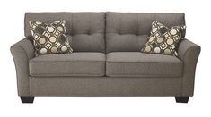 a gray couch with two pillows on it