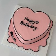 a pink heart shaped cake with the words happy birthday written on it's side