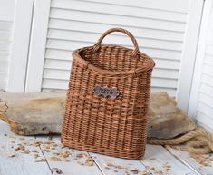 a brown wicker basket sitting on top of a wooden floor