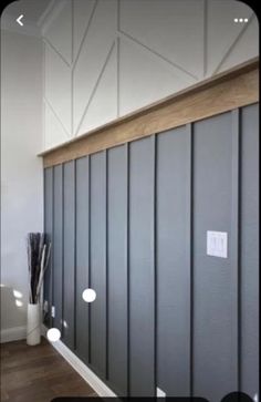 a room that has some gray walls and wood trimmings on the side of it