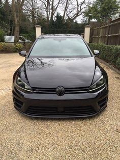 the front end of a black volkswagen golf