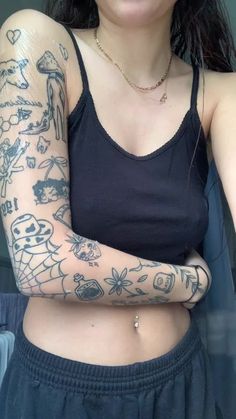 a woman with tattoos on her arm and chest