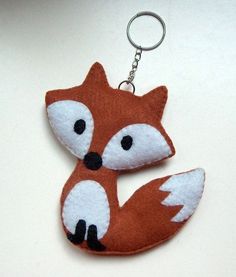 a keychain with a red fox design on it's front and back ends