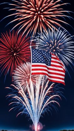 an american flag and fireworks in the night sky