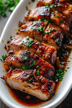 meat with sauce and parsley on a white plate