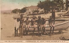 a group of men standing next to each other near a boat on the beach with palm trees in the background