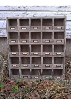 an old wooden box sitting in the grass