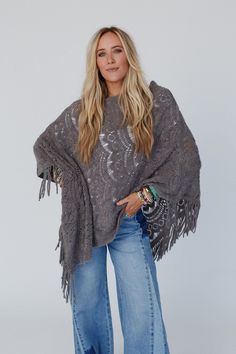 Get ready for the boho sweater of the season, the Sea Beyond Lace Poncho - it’s a true showstopper! This poncho is a must-have and a compliment magnet because it features: So pretty and unique, delicate, scalloped lace knit fabric Relaxed and loose poncho silhouette (no sleeves) So cute fringe details along the bottom edges for added boho style Lightweight layering piece to elevate any of your boho outfits! So pretty and flattering boho outfit pair with: Evermore Seamless Lace Racerback Bralette Bohemian Knit Poncho With Fringe, One Size Knit Poncho With Fringe, Bohemian Knit Poncho, Bohemian One-size Soft Knit Sweater, Bohemian Shawl Sweater For Fall, Bohemian Knit Poncho For Spring, Fall Bohemian Shawl Sweater, Bohemian Knit Sweater With Fringe, Fall Festival Oversized Poncho