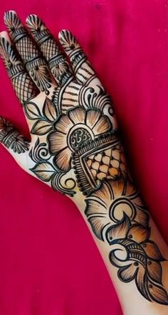 a woman's hand is decorated with hennap and intricate designs on it