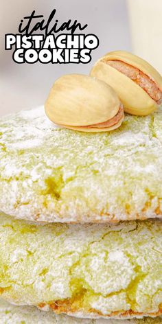 three cookies stacked on top of each other with pistachio toppings and powdered sugar