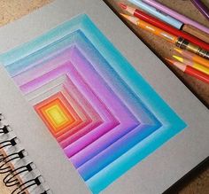 an open notebook with colored pencils next to it