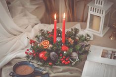 a table topped with candles and christmas decorations