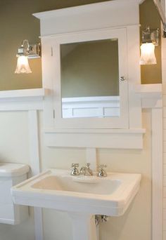 a white sink and mirror in a small bathroom