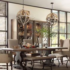 a dining room table with chairs and chandelier hanging from it's ceiling