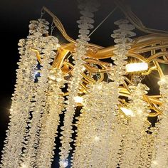 a chandelier with lights hanging from it's sides