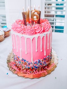 a birthday cake with pink frosting and sprinkles