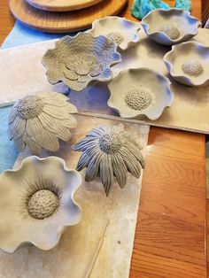 ceramic flowers are sitting on the table ready to be made