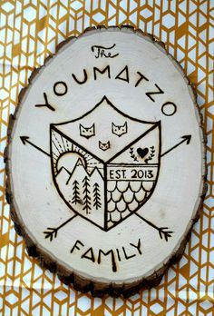 a wood slice with an owl on it and the words, the yomazo family