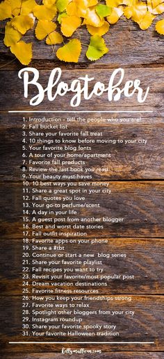 a wooden table with yellow leaves and the words blogtober written in white on it