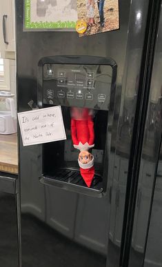 the elf is in the refrigerator with his feet up