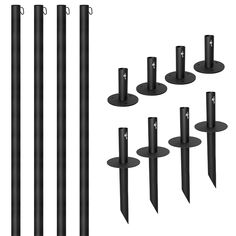 a set of six black poles and four round posts with one pole missing the end