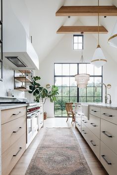 a kitchen with white cabinets and an area rug