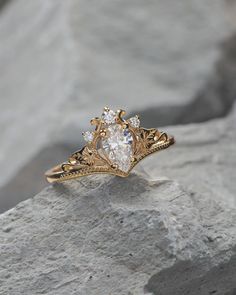 a diamond ring sitting on top of a rock