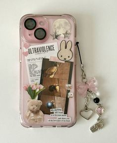 an iphone case with a keychain attached to it and some pictures on the back