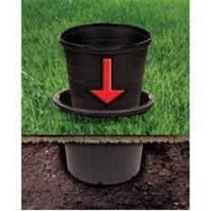 a black top hat with an arrow pointing to the right on grass and in ground