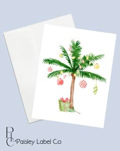 a palm tree with ornaments hanging from it's trunk is shown in front of a card