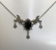 "This is a new handmade necklace. It is made with antiqued silver plated filigrees, accented with a high quality JET BLACK glass rhinestone. Decorated portion is 2 1/2\" wide and 1 3/4\" tall in the center. Necklace is adjustable 15-18\" with a lobster clasp and chain extender. If you would like a different length, please send us a message." Gothic Necklace Aesthetic, Romantic Goth Accessories, Gothic Silver Crescent Necklace, Gothic Crescent Silver Necklace, Adjustable Gothic Antique Silver Necklace, Adjustable Oxidized Gothic Necklace, Victorian Gothic Jewelry, Star Goddess, Dark Jewelry