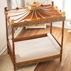 a small wooden table with a cushion on top