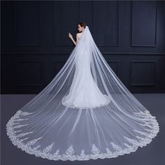 a bride's wedding veil with lace on the bottom and long, cathedral length